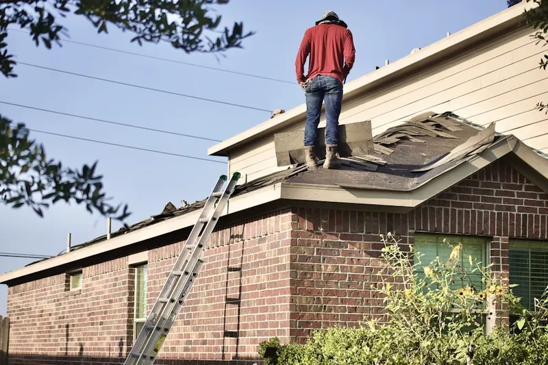 Professional roofer working on a residential roof in East Riverside